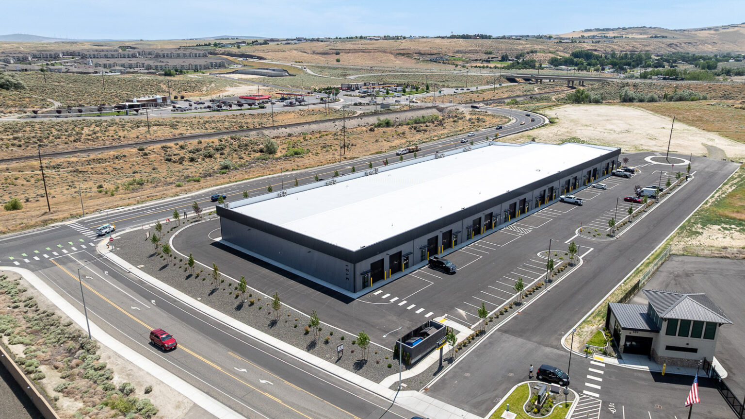 Aerial view of FlexSpace Business Centers showing modern commercial building and parking, Richland.